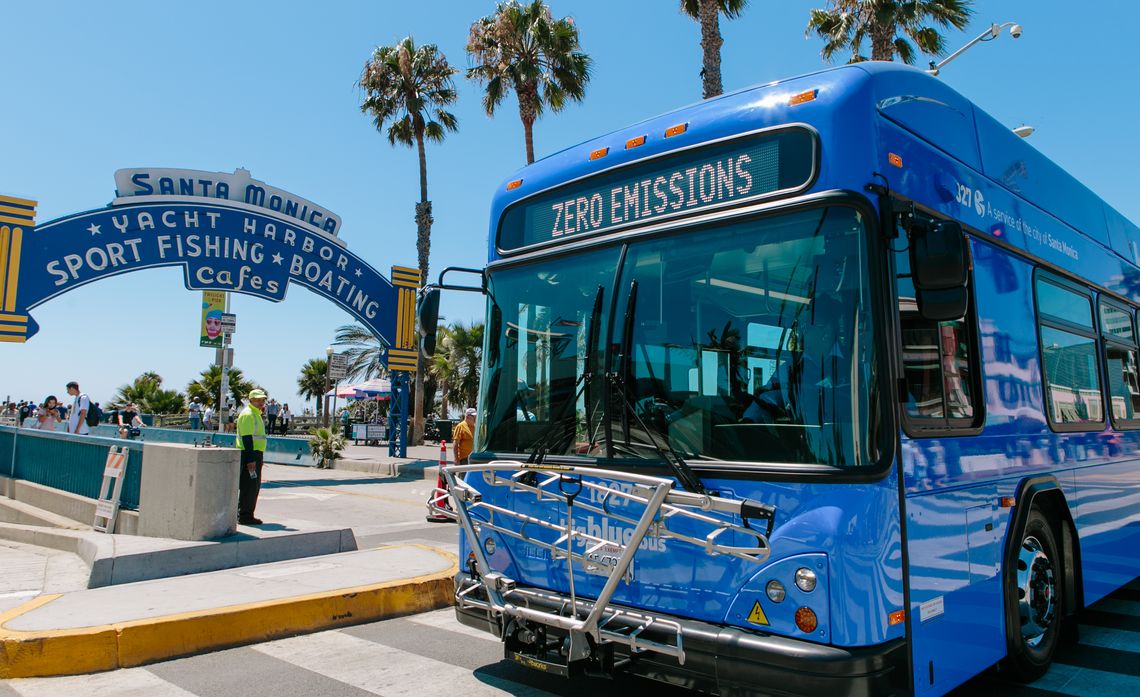 Santa Monica Big Blue Bus' Zero Emission Bus in front of the Santa Monica Pier sign